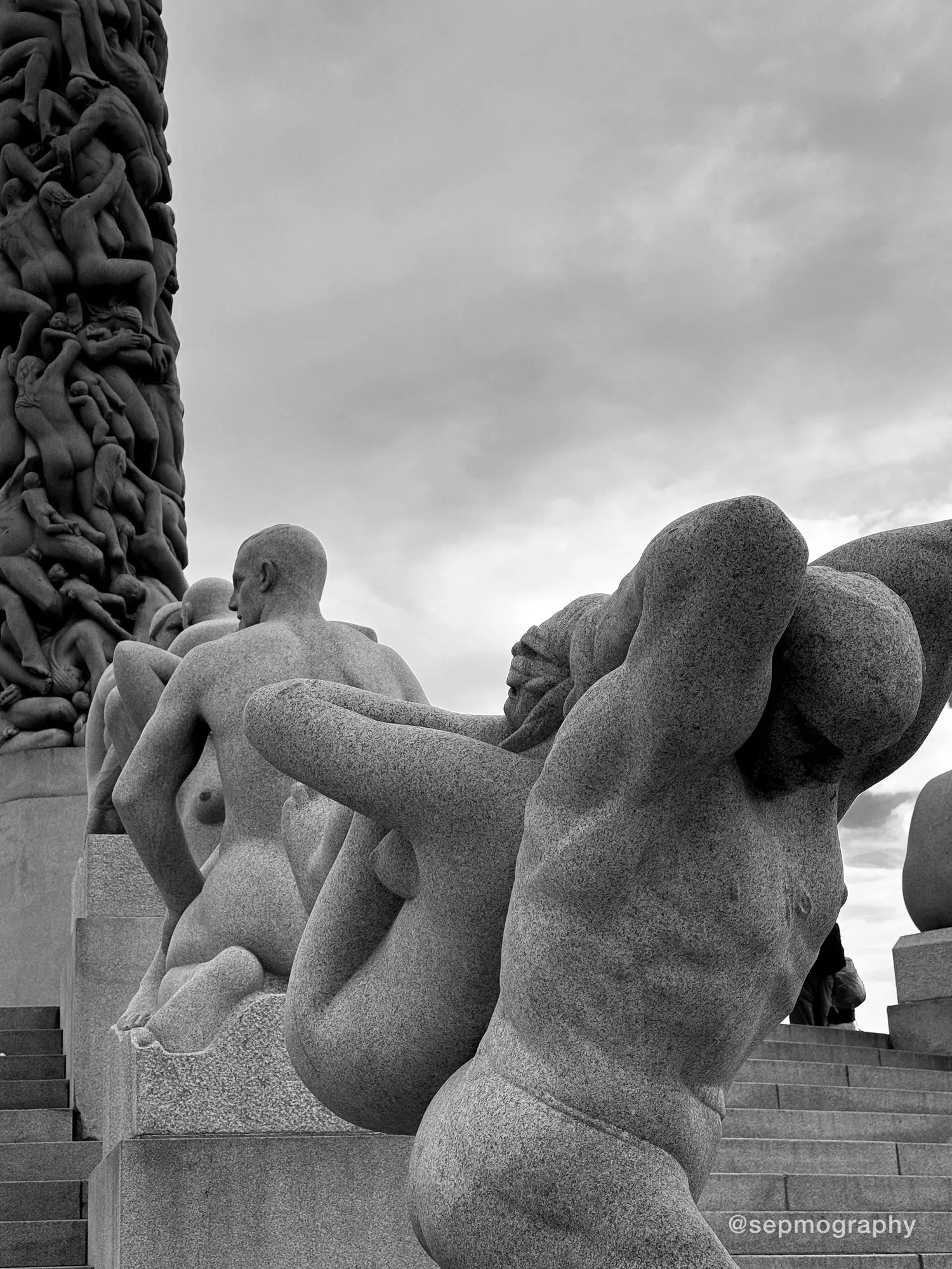 Granite figures on the steps around the monolith in Vigeland Park, in black and white
